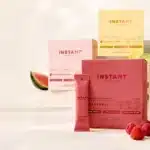 Where to Buy Jupi Hydration in 2026: Official Store, Amazon and Best Price Instant Hydration packets and electrolyte drink mix boxes in multiple flavors beside a clear water bottle